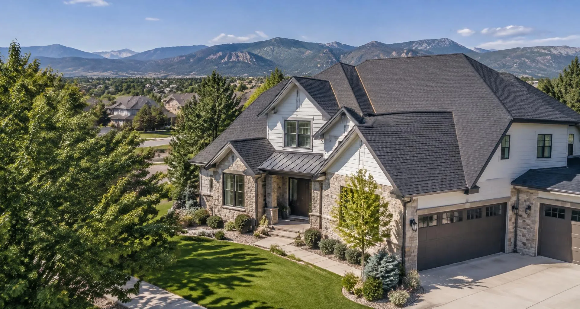 Colorado home with a charcoal architectural shingle roof and Front Range foothills beyond