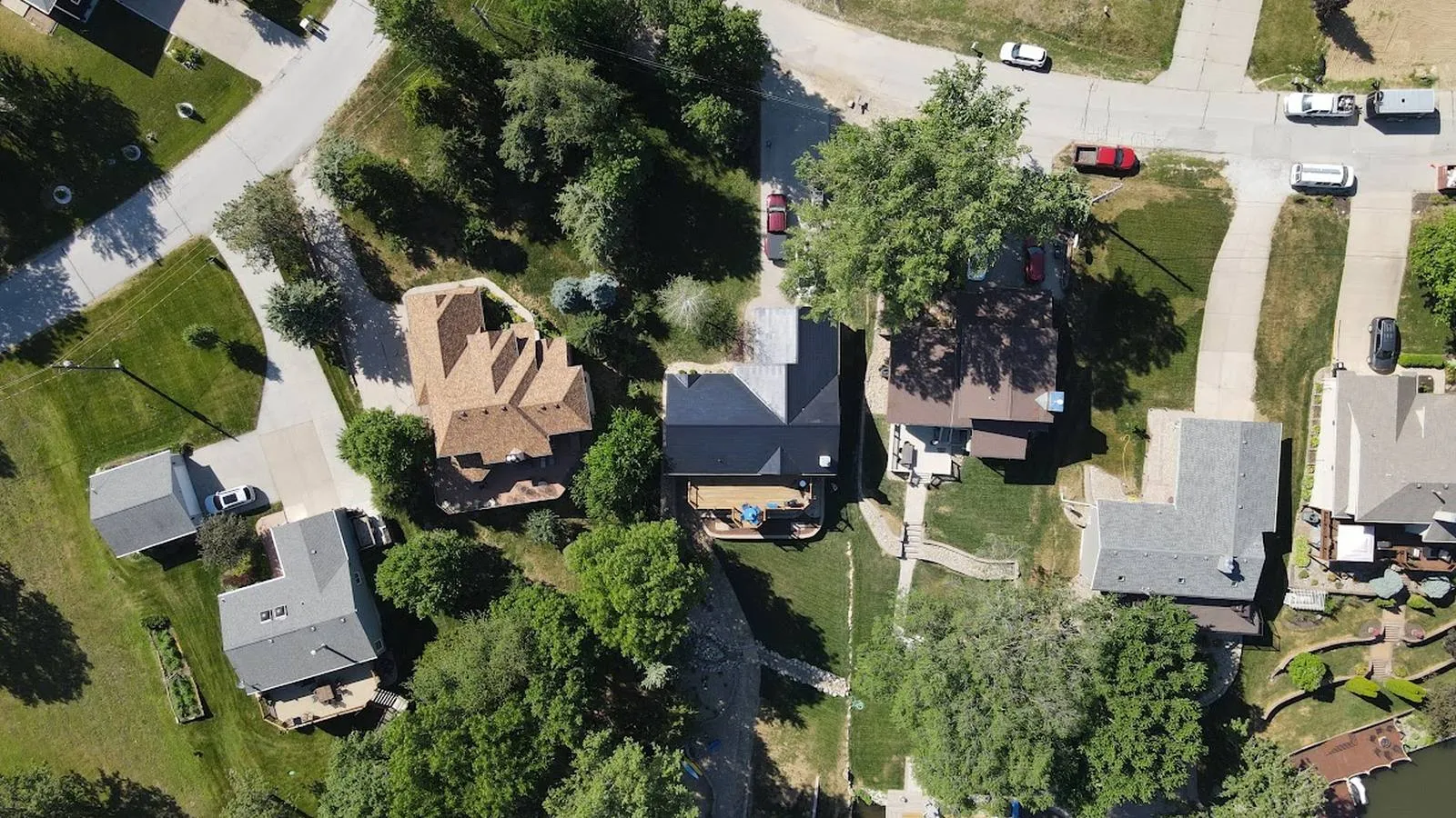 Overhead view of an Arvada, Colorado area neighborhood with new roofs among mature trees