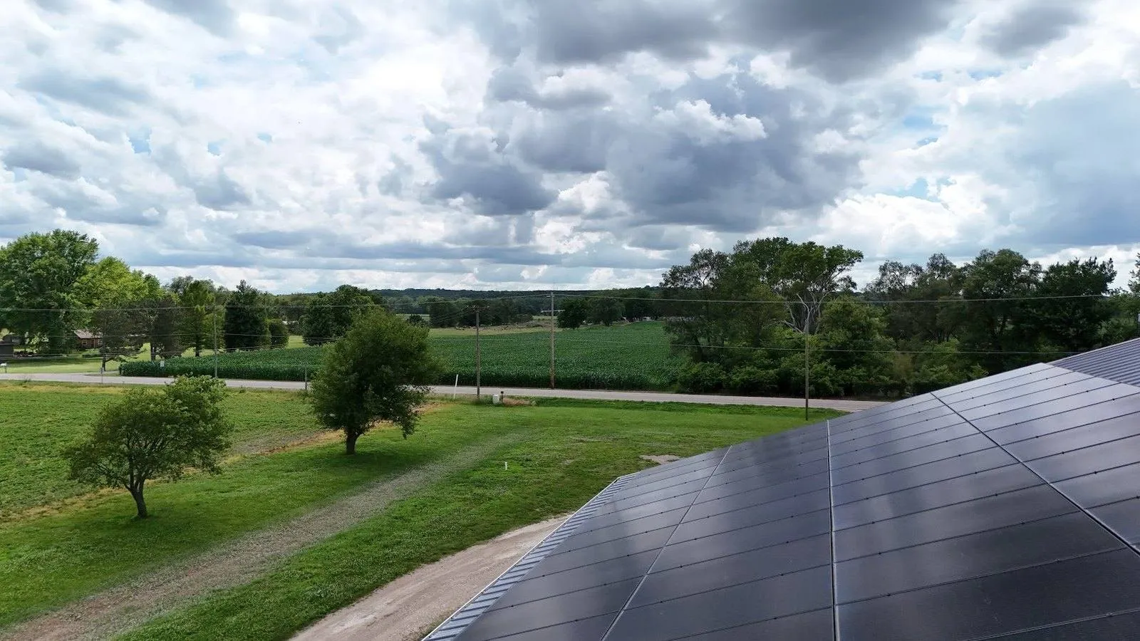 Rooftop solar panels on an acreage home outside Bennet, Nebraska overlooking green fields and country road