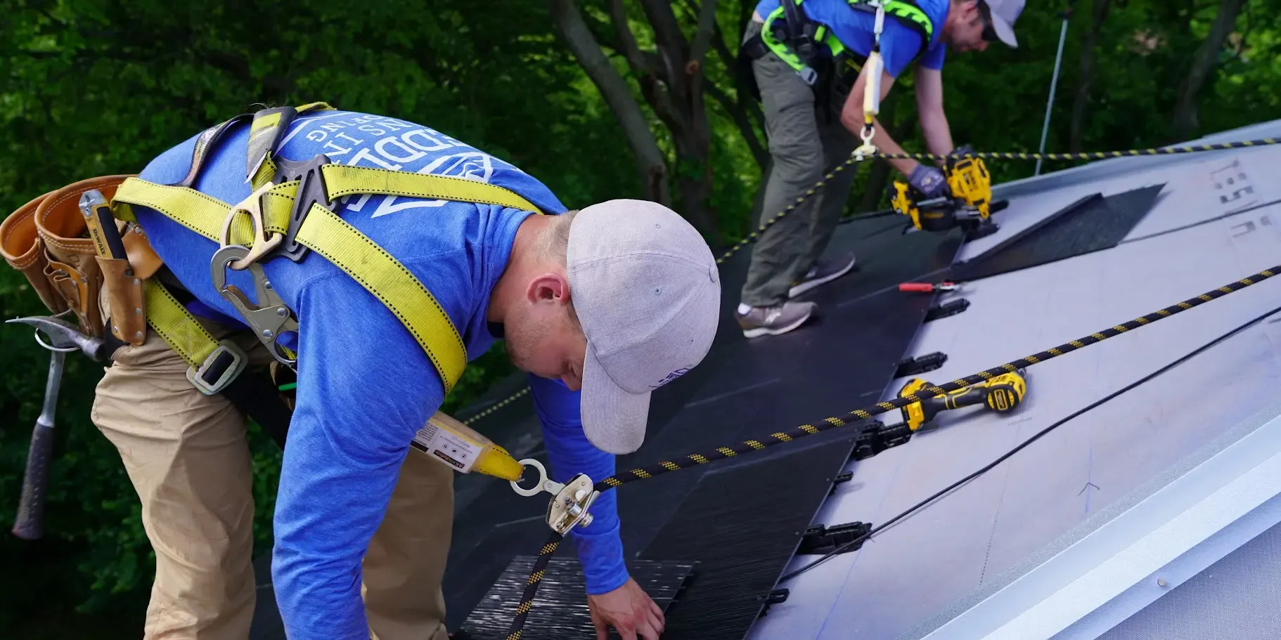 Weddle and Sons crew members in harnesses installing a solar roof
