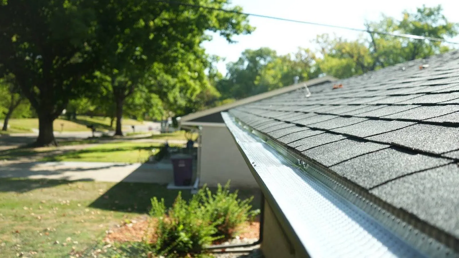 New gutter guard installed along an architectural shingle roof, serving Centennial, Colorado