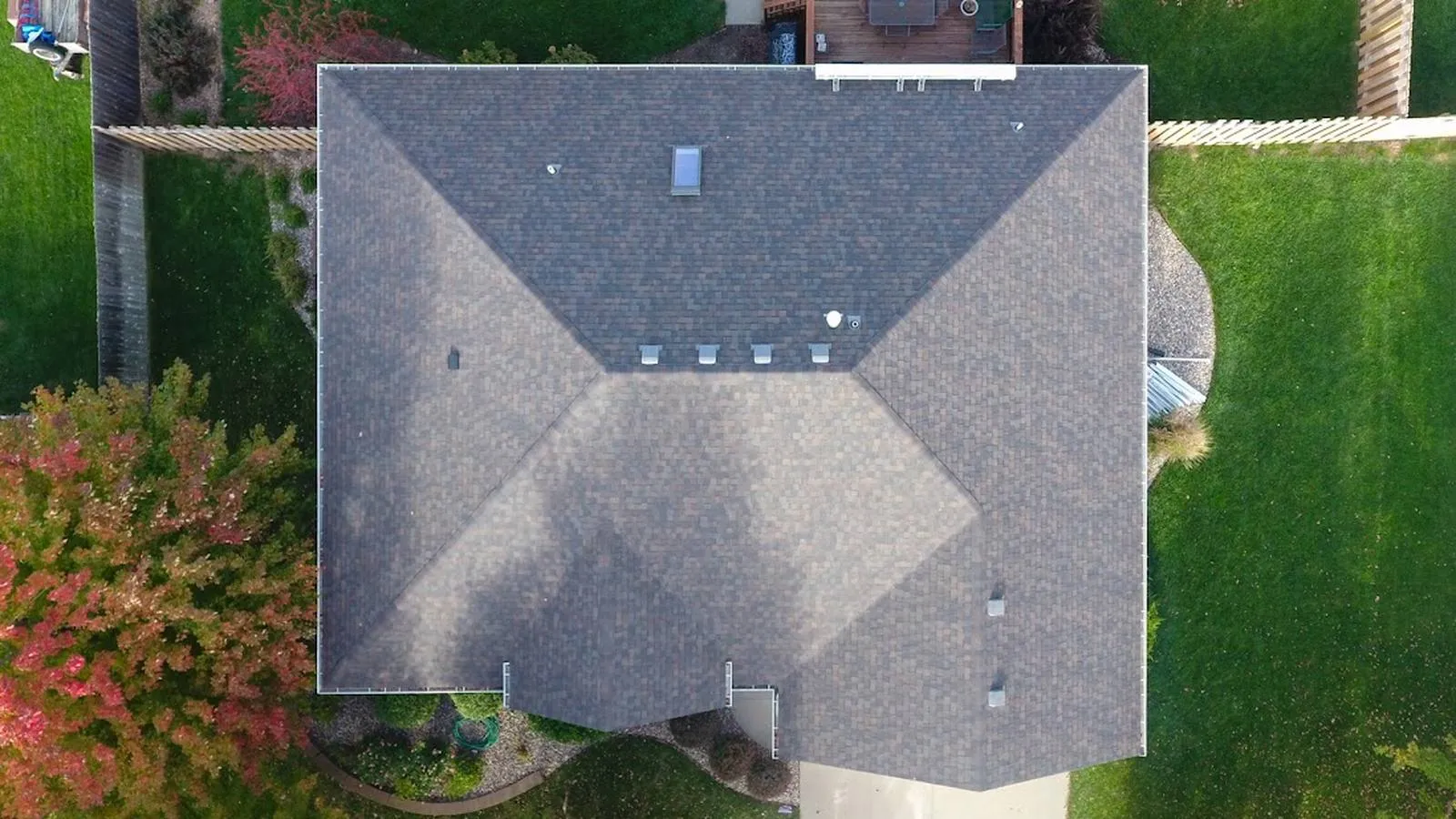 Overhead view of an Eagle, Nebraska home with a new architectural shingle hip roof and backyard deck