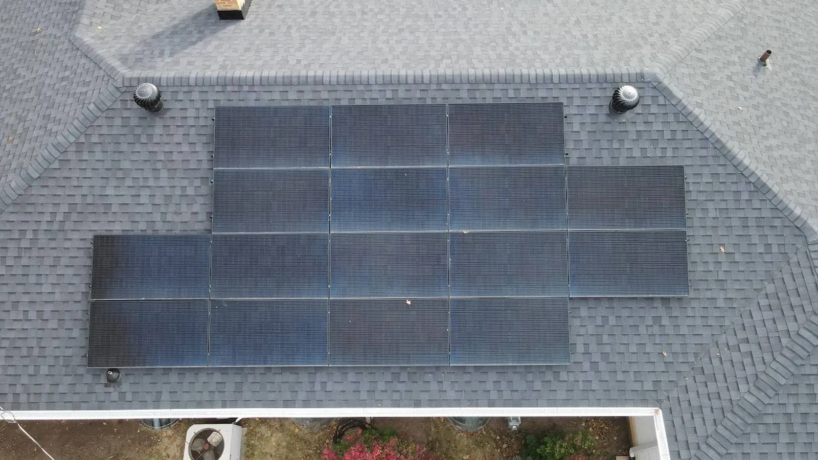 Overhead aerial view of a Gardner, Kansas home with a new shingle roof and a centered rooftop solar array