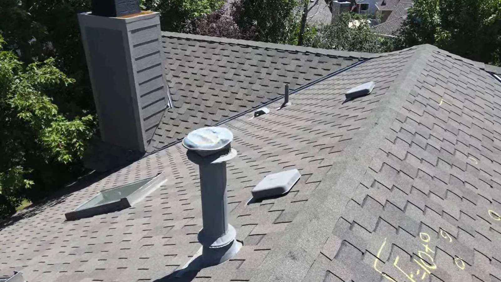 Roof inspection on a shingle roof with vents and a chimney, serving Lakewood, Colorado