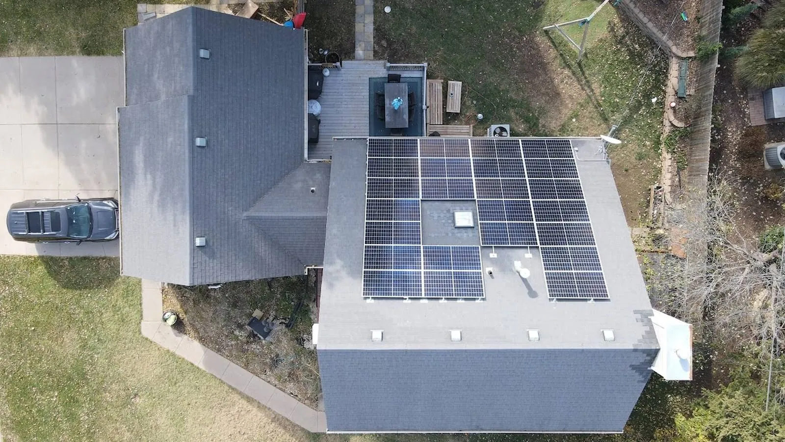 Overhead aerial view of a Leawood, Kansas home with a new dimensional shingle roof and rooftop solar panels