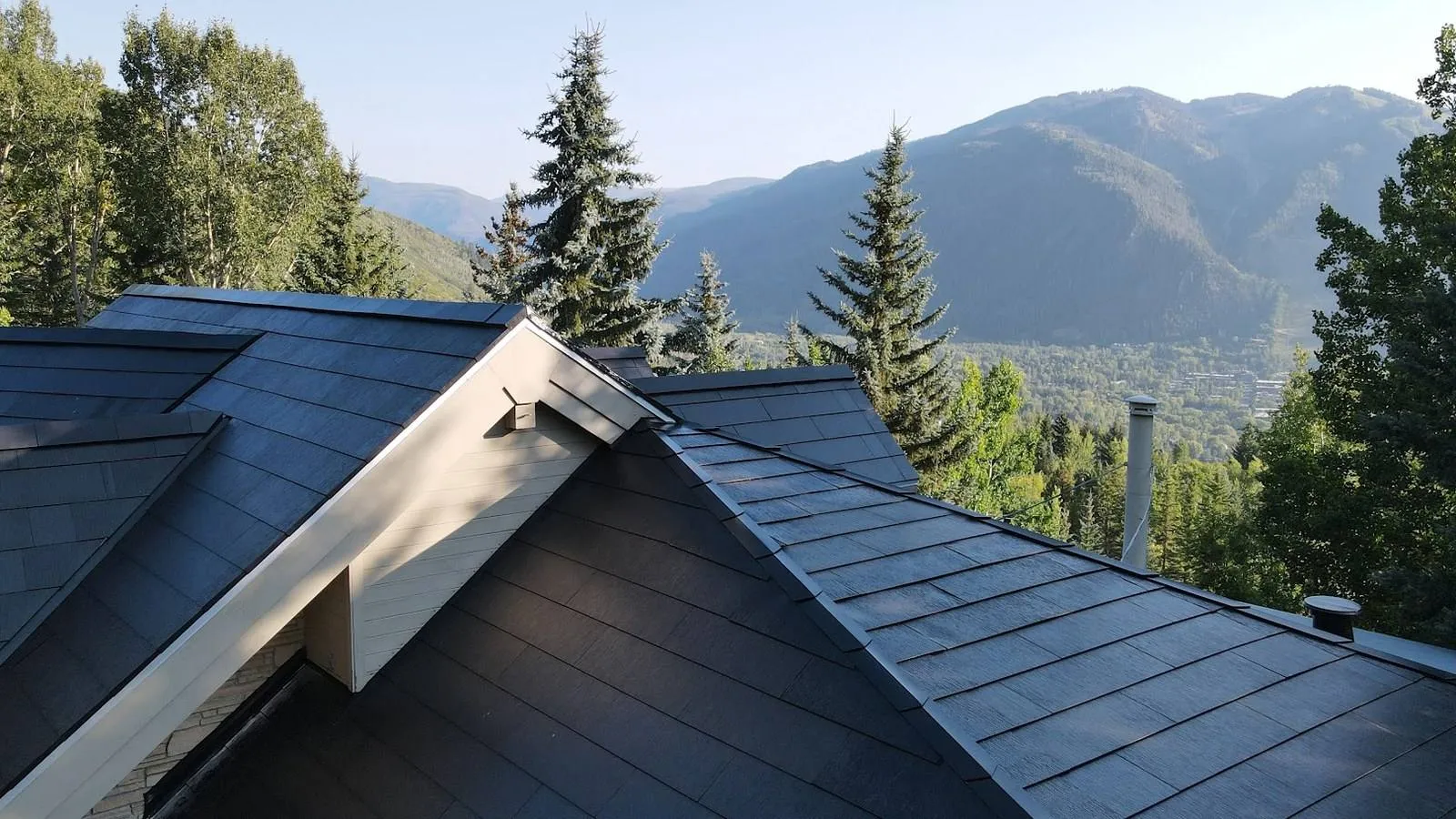 Dark solar shingle roof on a Colorado home near Longmont with foothill mountain views