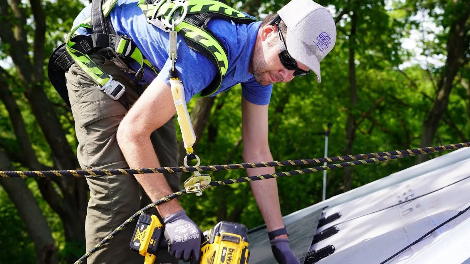 Weddle and Sons roofer tied off with a safety line installing a new roof in Northglenn, Colorado