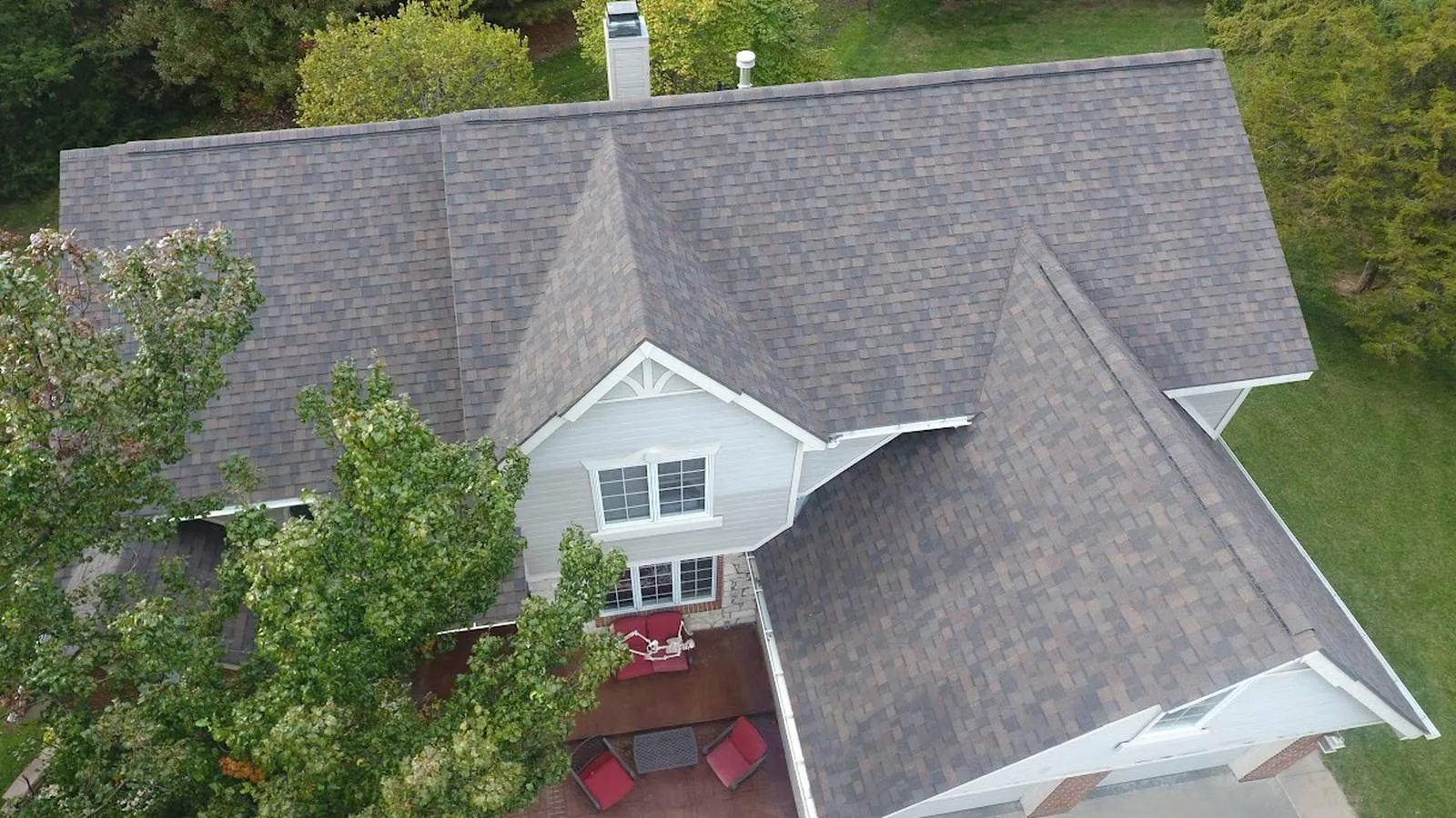 Aerial view of a Papillion, Nebraska home with a new multi tone architectural shingle roof and backyard patio