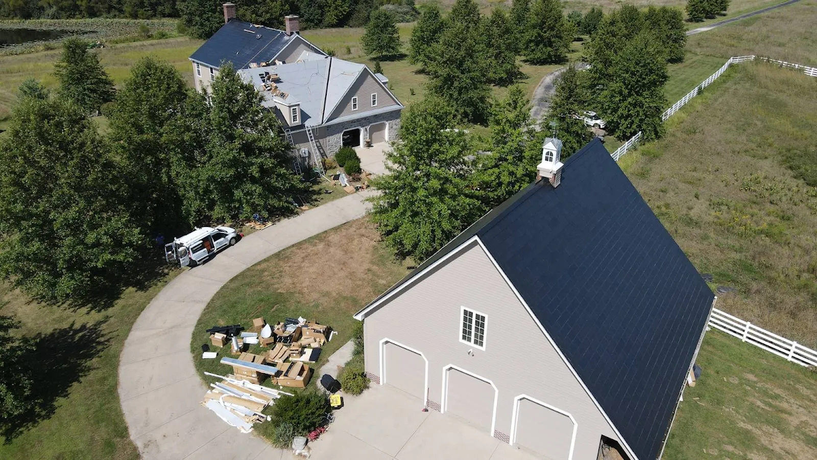 Aerial view of a Weddle and Sons solar roof project on an acreage home and garage, serving Parker, Colorado