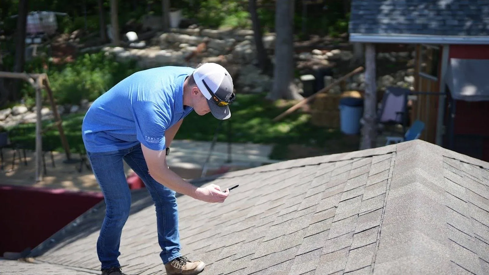 Weddle and Sons inspector documenting shingle condition during a roof inspection near Perry, Kansas
