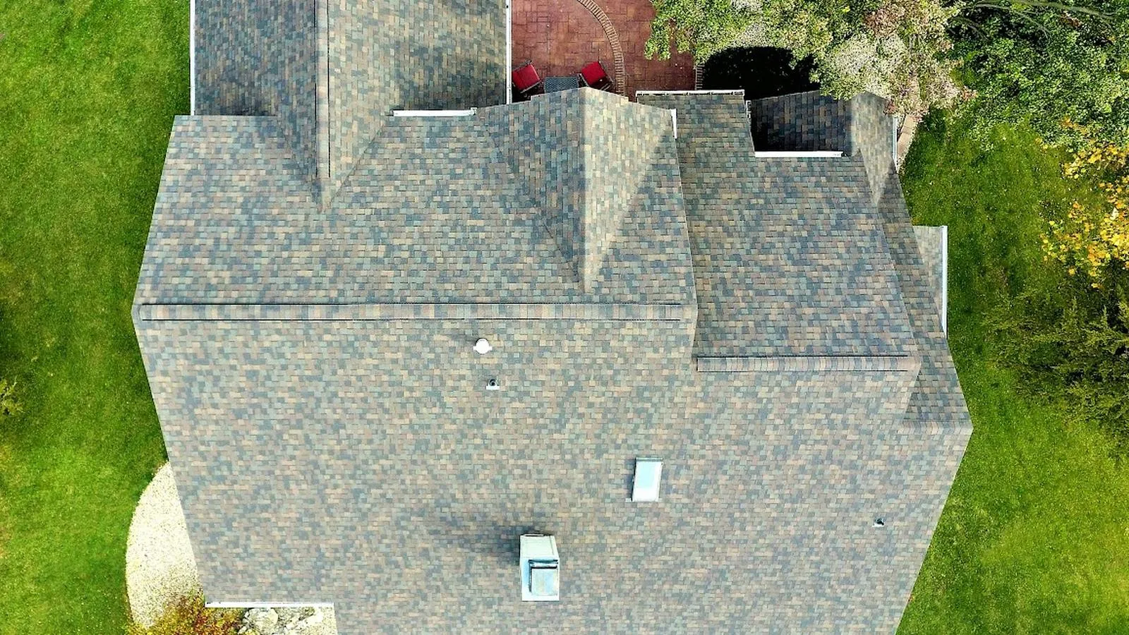 Overhead view of a Sabetha, Kansas home with a new multi tone architectural shingle roof and backyard deck