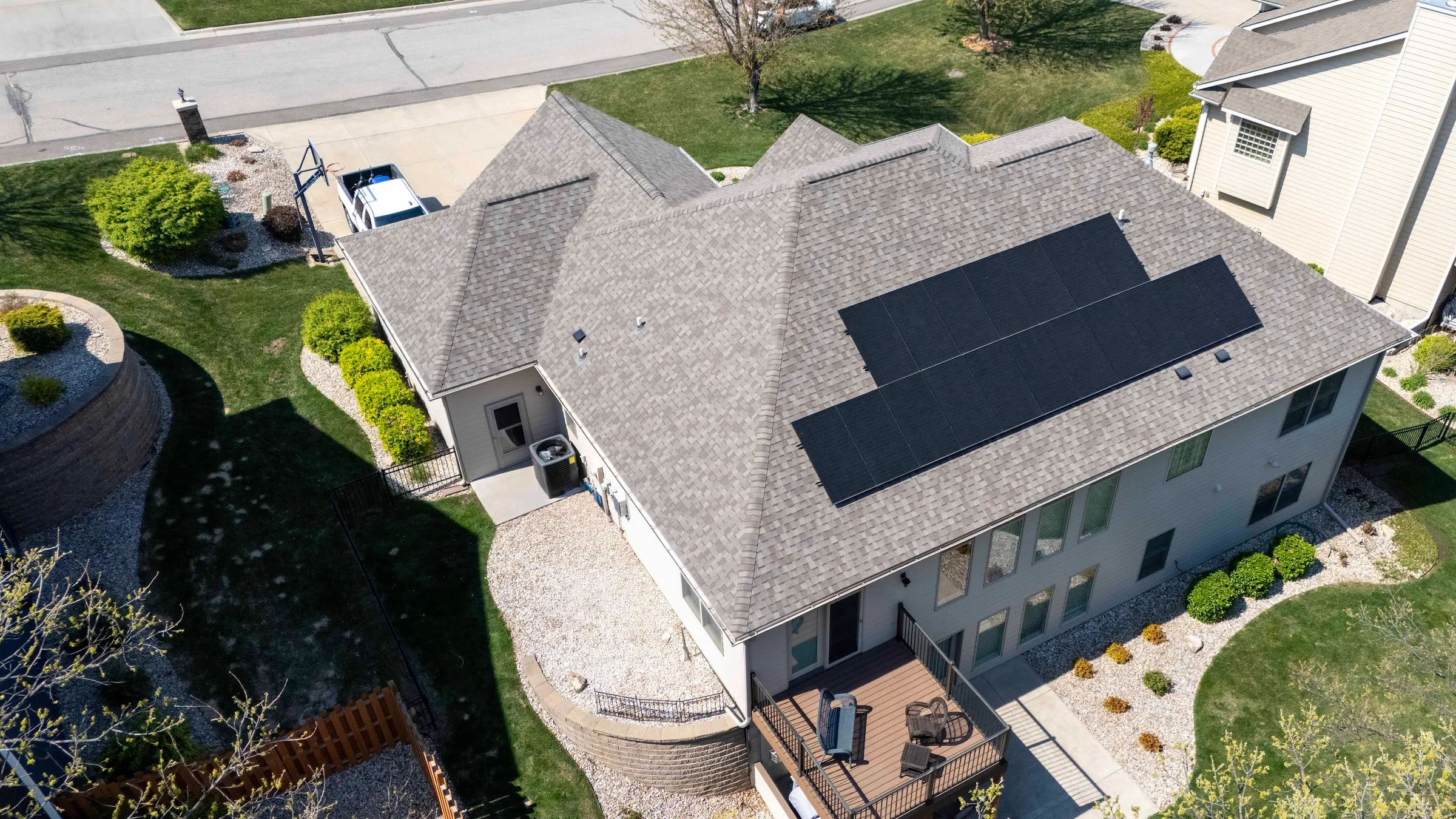 Aerial view of solar panels installed on a residential shingle roof