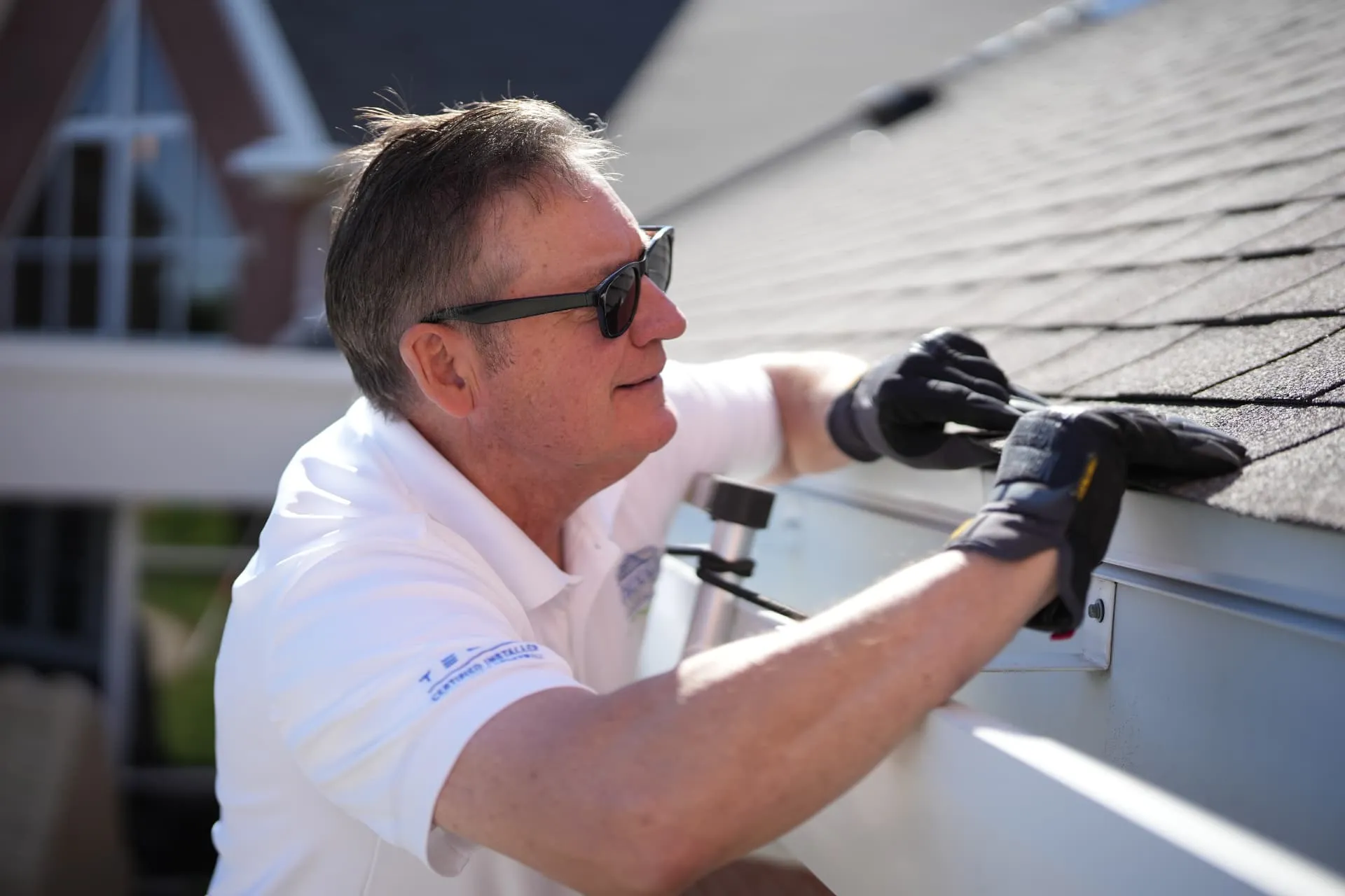 Weddle & Sons inspector examining shingles during a free roof inspection